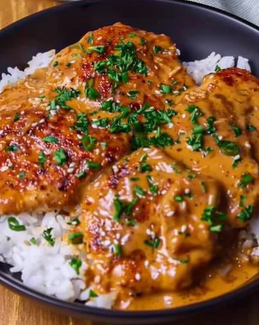 Creamy Cajun Chicken 2 Delicious creamy Cajun chicken served on a plate with herbs and spices.