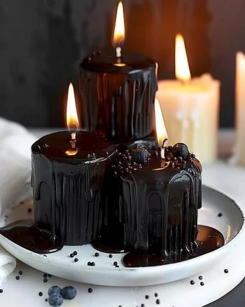 Melted candle cupcakes showcasing colorful frosting and decorative candles on top.