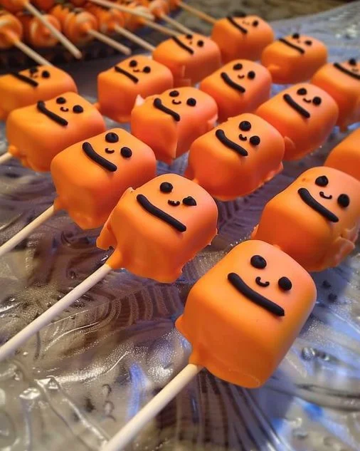 Delicious homemade Pumpkin Marshmallow Lollipops in decorative packaging.