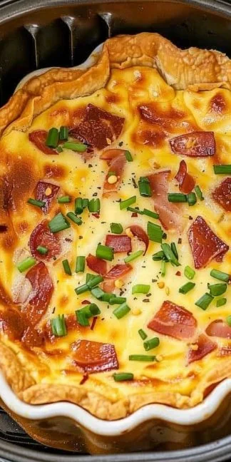 Delicious air fryer crack quiche slice on a plate with fresh herbs