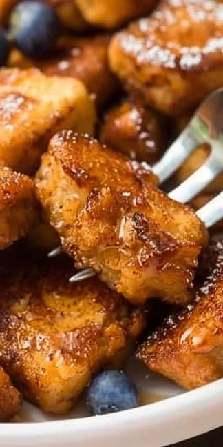 Delicious Air Fryer French Toast Bites served with syrup and berries