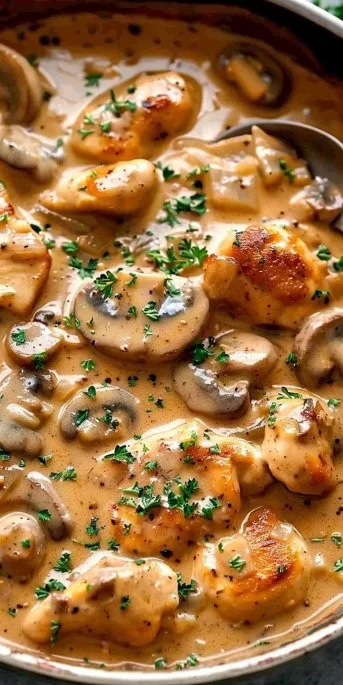 Delicious bowl of Chicken Stroganoff served with pasta and fresh parsley.