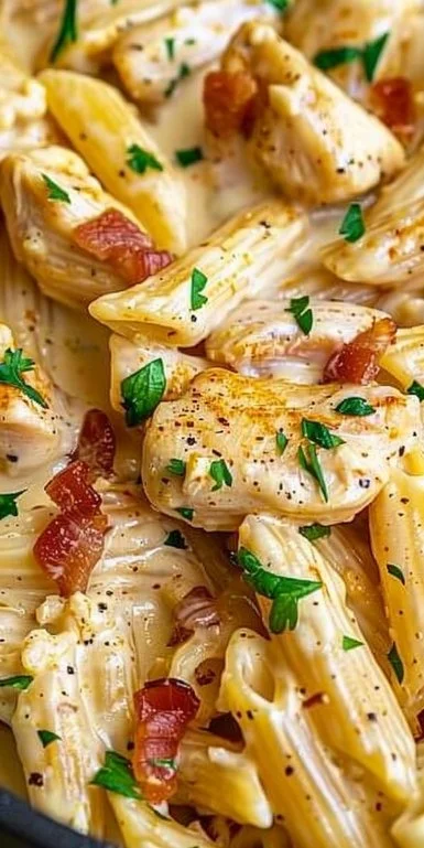 Crock Pot Creamy Cajun Chicken Pasta dish in a bowl garnished with herbs