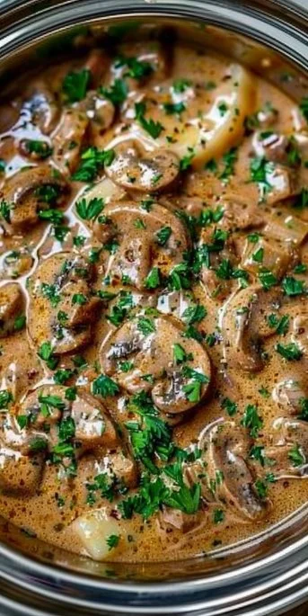 Crockpot Beef Stroganoff 3 Delicious Crockpot Beef Stroganoff served in a bowl with pasta and herbs