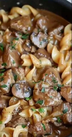 Easy beef stroganoff served with noodles and garnished with parsley