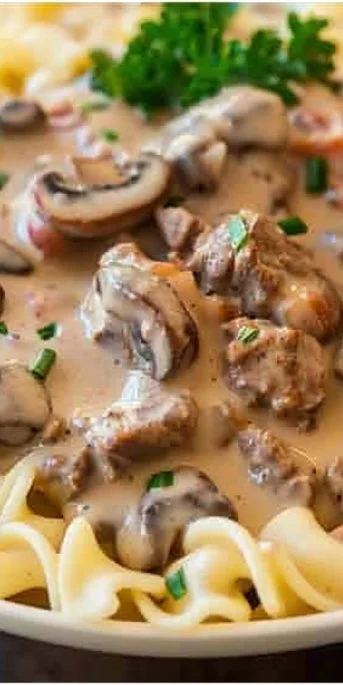 Easy Beef Stroganoff 3 Delicious easy beef stroganoff served with noodles and garnished with parsley.