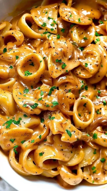 Delicious Easy French Onion Pasta topped with cheese and caramelized onions