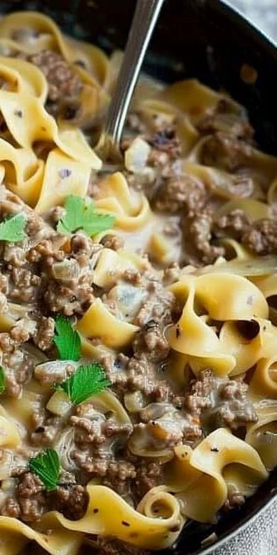 Delicious easy ground beef stroganoff served on a plate with noodles and parsley