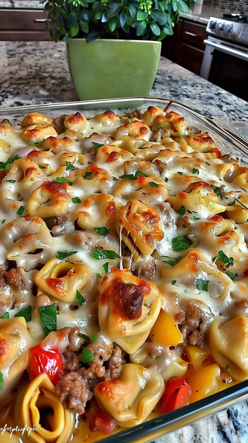 Golden cheese steak tortellini casserole served in a baking dish