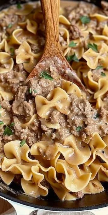 Ground Beef Stroganoff served with pasta and garnished with parsley