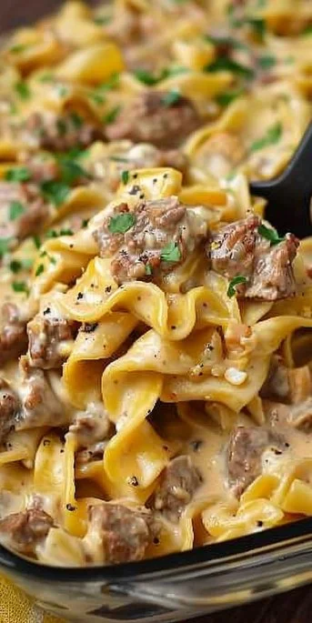 Plate of creamy Ground Beef Stroganoff served with egg noodles and garnished with parsley