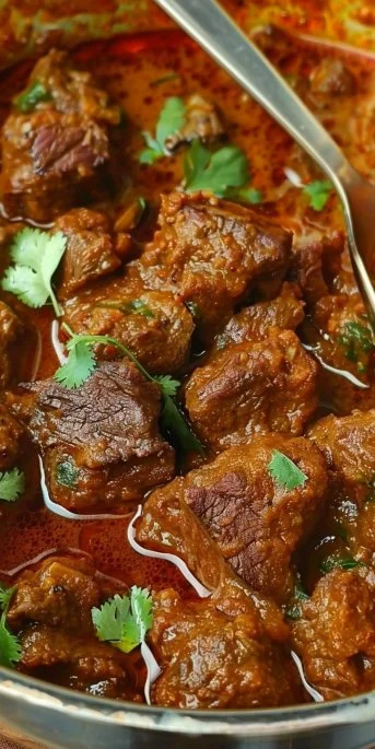 Delicious Indian Beef Curry served with rice and garnished with cilantro