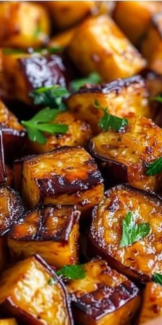 Crispy low-calorie air fryer eggplant on a plate, garnished with herbs.