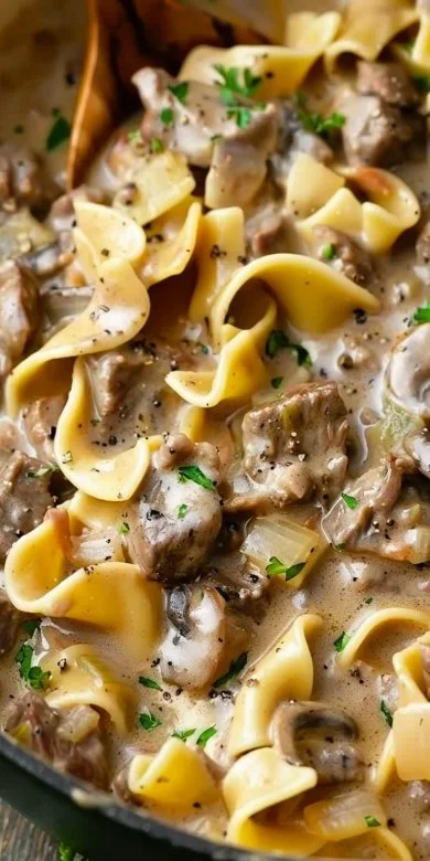 Delicious Slow Cooker Beef Stroganoff served with creamy sauce over noodles