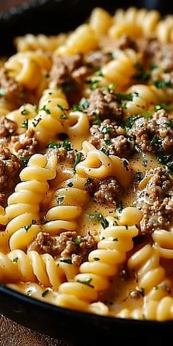 Stovetop creamy ground beef pasta served in a bowl with fresh herbs.