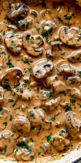 Creamy vegetarian mushroom stroganoff served in a bowl with fresh herbs