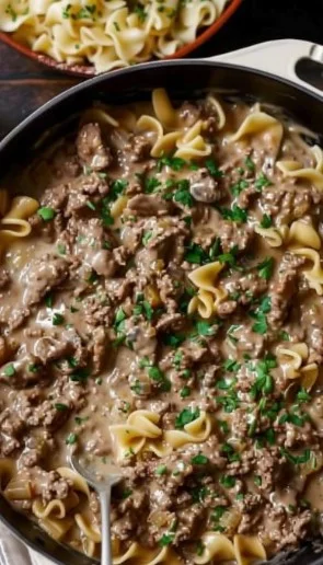 Delicious ground beef stroganoff served with noodles and garnished with parsley
