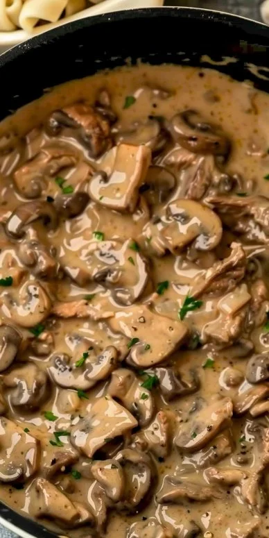 Plate of delicious Beef Stroganoff with noodles and parsley garnish