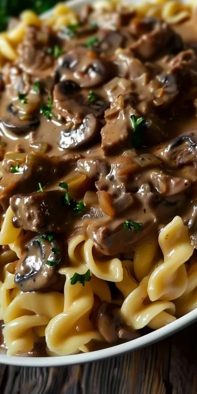 Delicious Beef Stroganoff Casserole topped with cheese and herbs