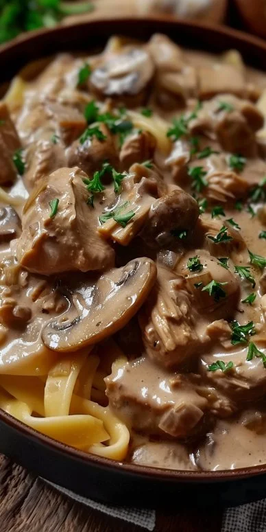 Creamy Chicken Mushroom Stroganoff served in a bowl with fresh herbs