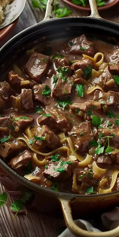 Creamy Dutch Oven Beef Stroganoff with mushrooms and pasta served in a bowl