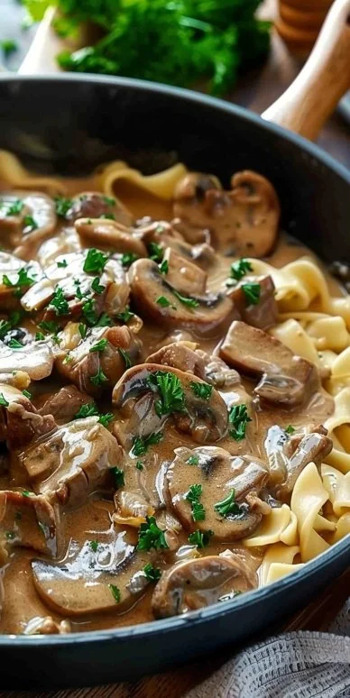Delicious beef stroganoff served with pasta and garnished with parsley