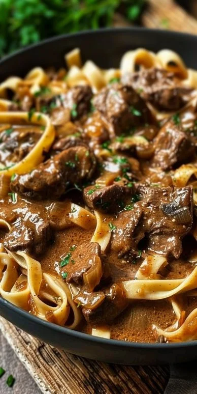 Delicious easy beef stroganoff topped with parsley and served over noodles.