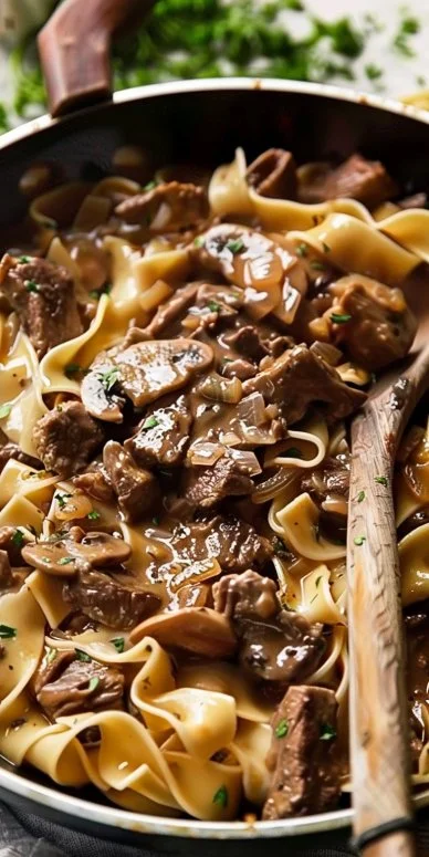 Delicious easy beef stroganoff served over noodles with creamy sauce.