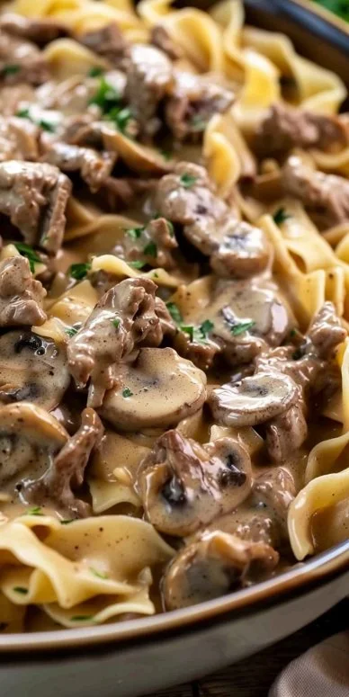 Easy beef stroganoff dish served with noodles and garnished with parsley