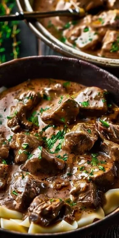 Delicious plate of Beef Stroganoff garnished with parsley served in a bowl.