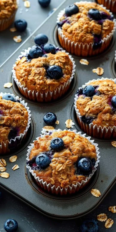 Freshly baked blueberry oatmeal muffins on a rustic wooden table