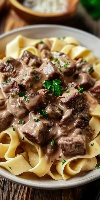 Delicious slow-cooker beef stroganoff served with noodles.