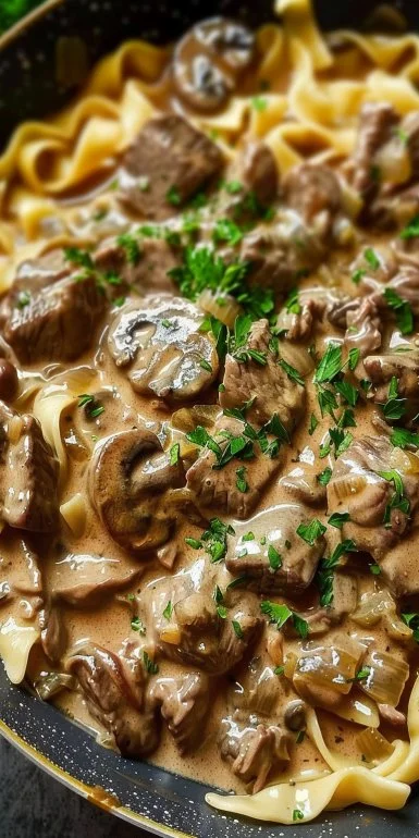Beef Stroganoff Recipe for a Creamy, Satisfying Dinner 4 Delicious Beef Stroganoff served with pasta and garnished with parsley.