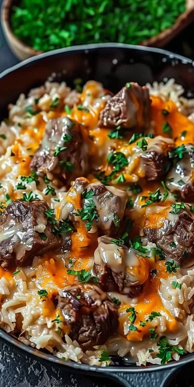 Cheesy Steak and Rice Skillet 4 Cheesy Steak and Rice Skillet served in a pan with fresh herbs
