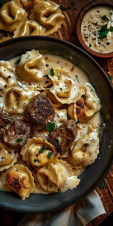 Delicious Cracked Garlic Steak Tortellini served in creamy sauce