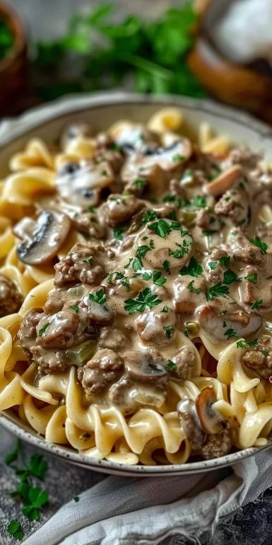 Delicious creamy ground beef stroganoff served in a bowl with fresh herbs