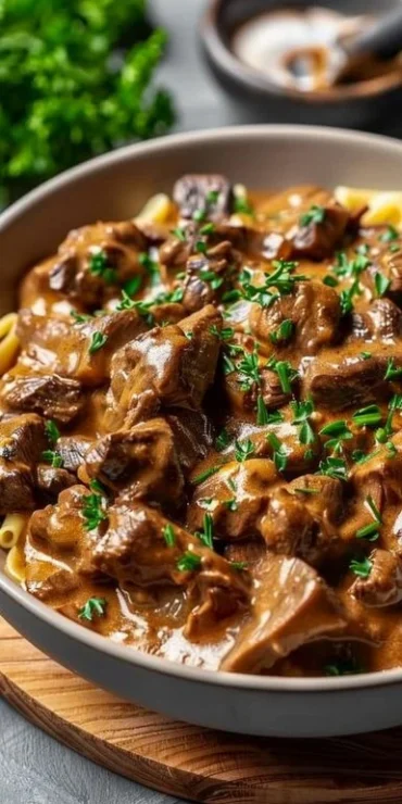 Delicious crockpot beef stroganoff served with egg noodles