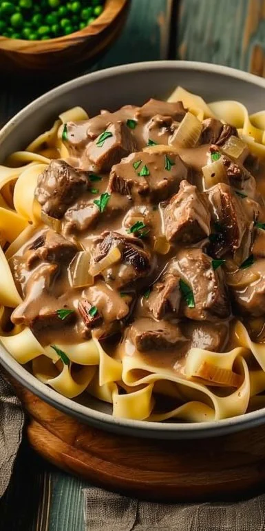 Crockpot Beef Stroganoff in a bowl with creamy sauce and tender beef slices