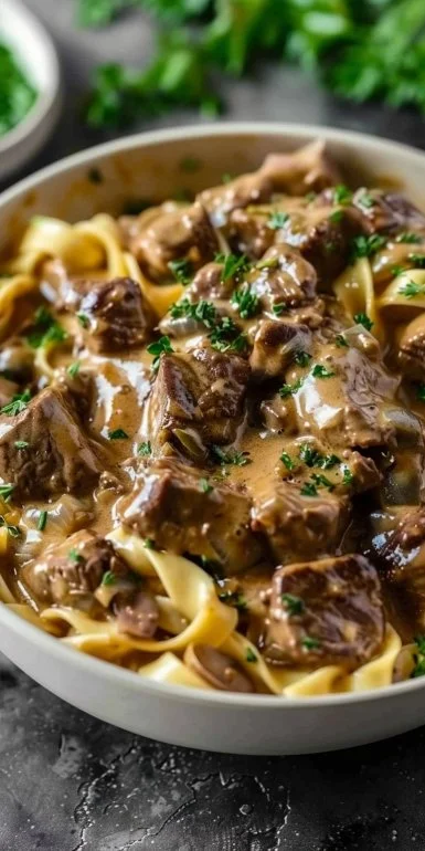Delicious easy beef stroganoff served with noodles and fresh parsley