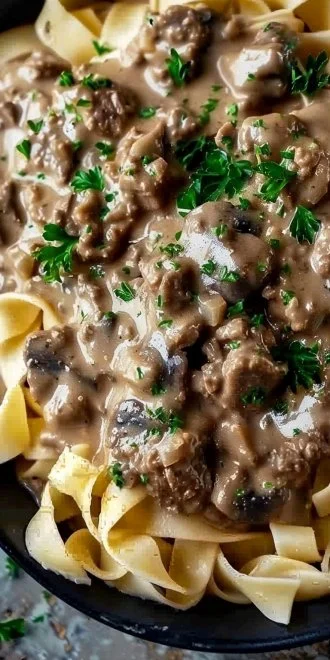 Delicious Ground Beef Stroganoff served in a bowl with noodles and garnished