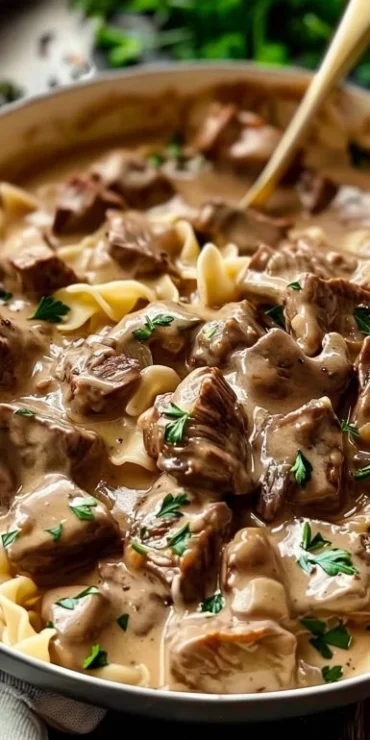 Indulgent slow cooker beef stroganoff dish on a rustic table
