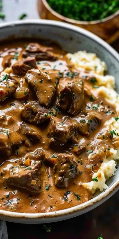 Keto Crockpot Beef Stroganoff served in a bowl with herbs on top