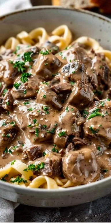 Slow cooker creamy beef stroganoff with tender beef and rich sauce in a bowl