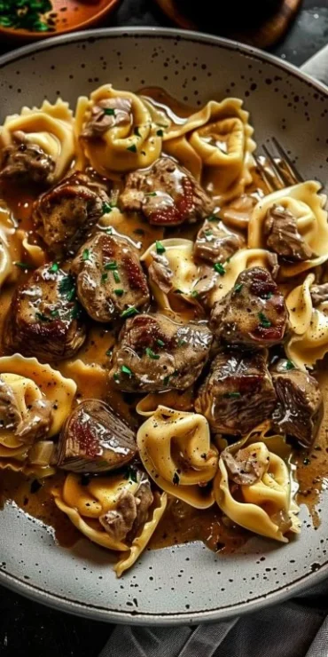 Cracked garlic steak tortellini served in a creamy sauce dish