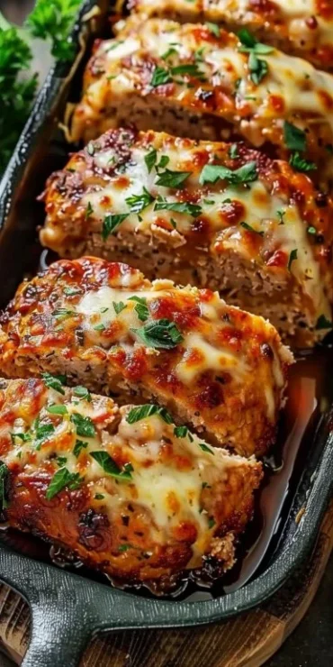 Delicious Garlic Parmesan Chicken Meatloaf served with herbs and spices.